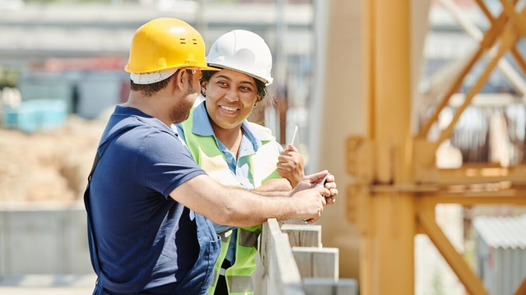 Trade Certification Recognition in Kyrgyzstan: AWS, ASME & ISO Standards for South Asian Workers Two workers in hard hats discussing on site — AWS, ASME and ISO trade certification recognition in Kyrgyzstan